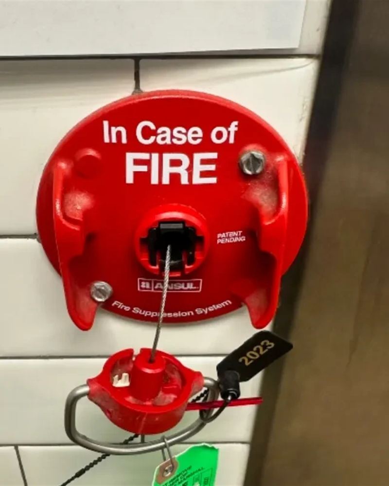 Ansul kitchen hood suppression pull station with inspection tag
