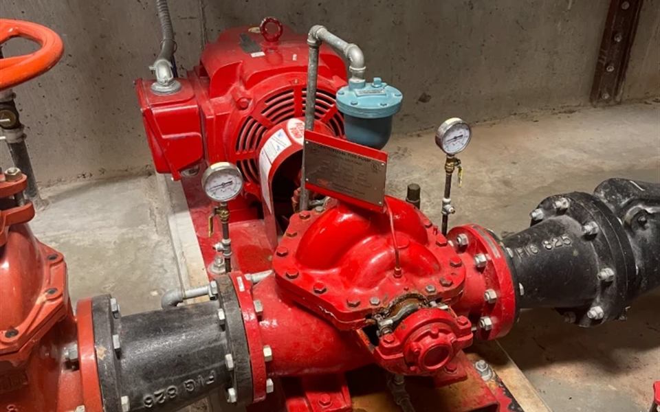 Red split-case fire pump with flanged suction and discharge piping